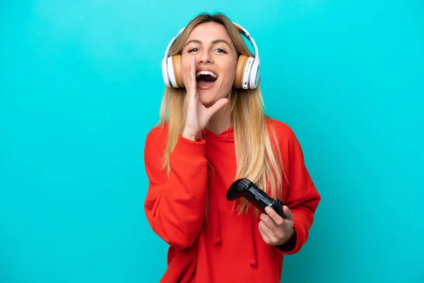 Young Uruguayan Woman Playing Video Game Controller Isolated Blue Shouting —  Fotos de Stock