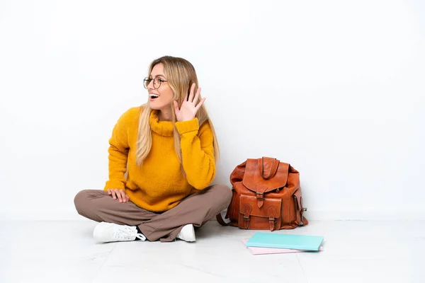 Uruguayan Student Woman Sitting One Floor Isolated White Background Listening — стоковое фото