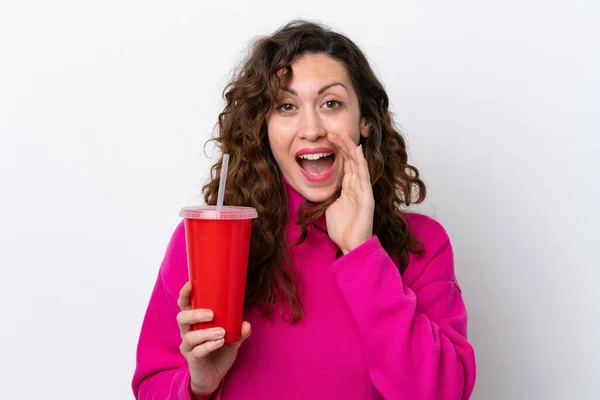 Young Caucasian Woman Drinking Soda Isolated White Background Shouting Mouth — стоковое фото