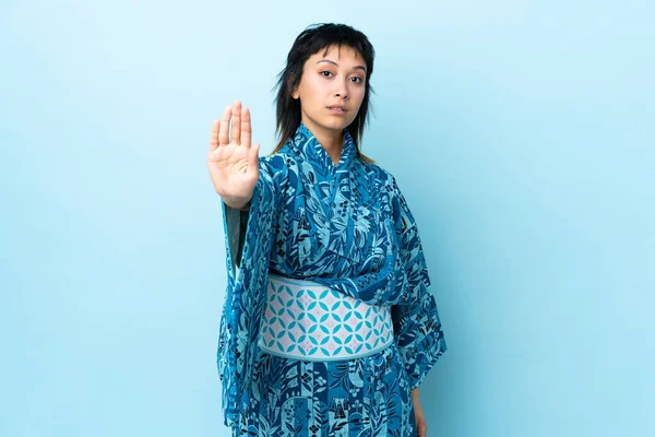 Young Woman Wearing Kimono Isolated Blue Background Making Stop Gesture — 스톡 사진