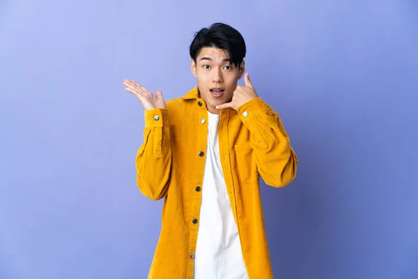 Young Chinese Man Isolated Purple Background Making Phone Gesture Doubting — Stockfoto