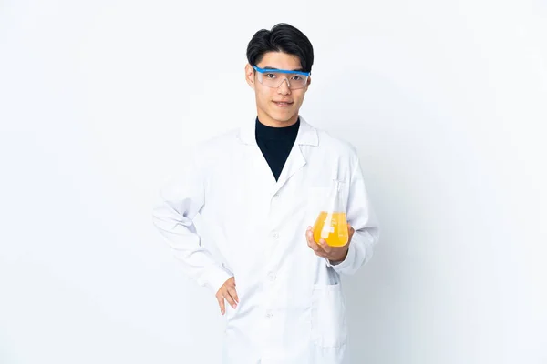 Young Chinese scientific man isolated on white background posing with arms at hip and smiling