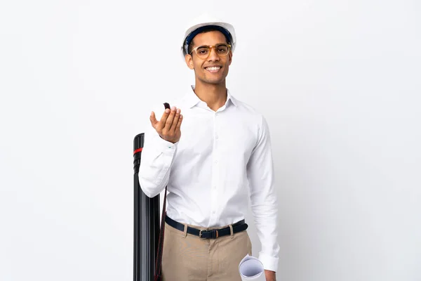 African American architect man with helmet and holding blueprints over isolated white background _ inviting to come with hand. Happy that you came