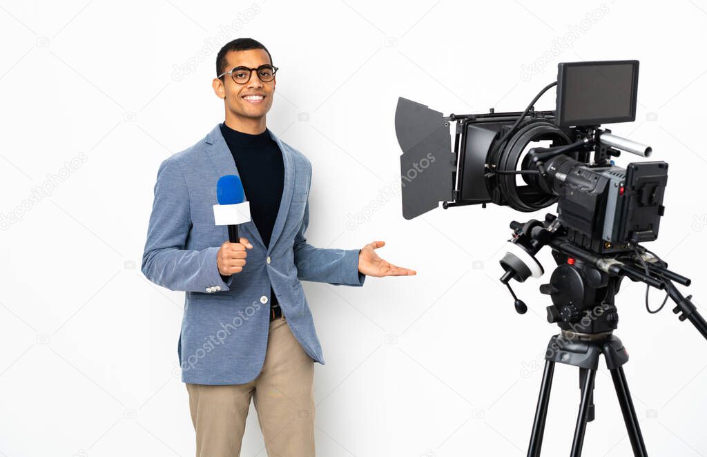 Reporter African American man holding a microphone and reporting news over isolated white background extending hands to the side for inviting to come
