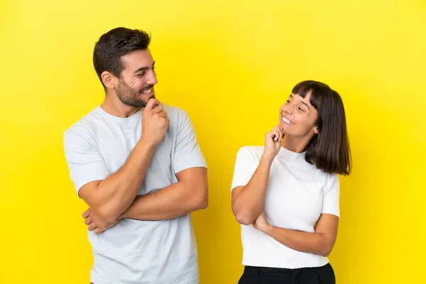 Young Couple Isolated Yellow Background Looking Looking Each Other — 图库照片