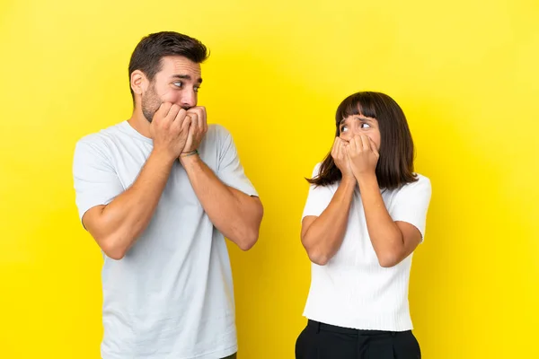 Young Couple Isolated Yellow Background Little Bit Nervous Scared Putting — 图库照片