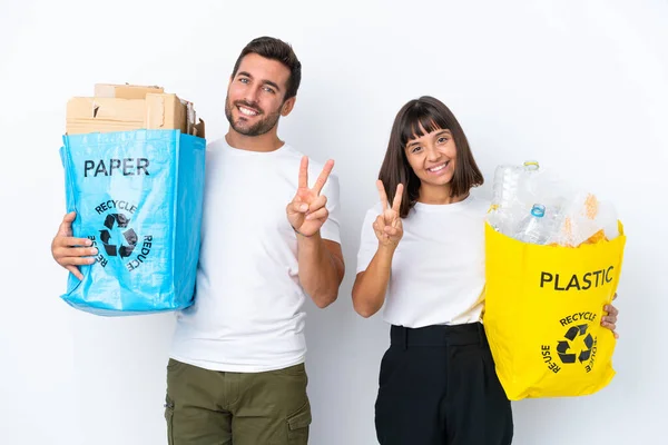 Young Couple Holding Bag Full Plastic Paper Recycle Isolated White — Fotografia de Stock