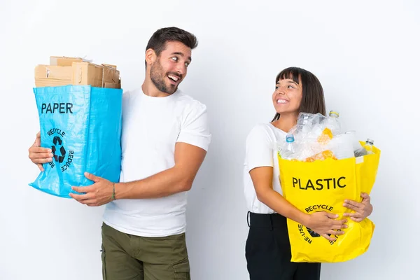 Young Couple Holding Bag Full Plastic Paper Recycle Isolated White —  Fotos de Stock