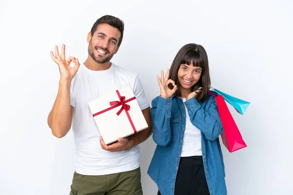 Young Couple Holding Shopping Bags Present Isolated White Background Showing — Stockfoto