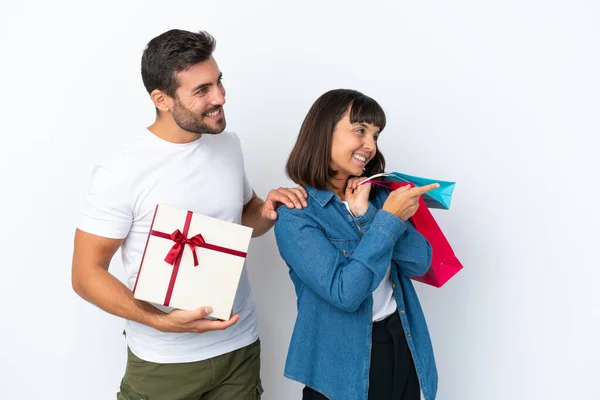 Young Couple Holding Shopping Bags Present Isolated White Background Presenting — Stockfoto
