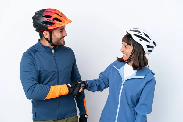 Young Cyclist Couple Isolated White Background Handshaking Good Deal — Stock Fotó