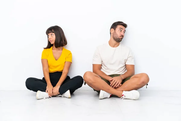 Young Couple Sitting Floor Isolated White Background Nervous Scared — Fotografia de Stock