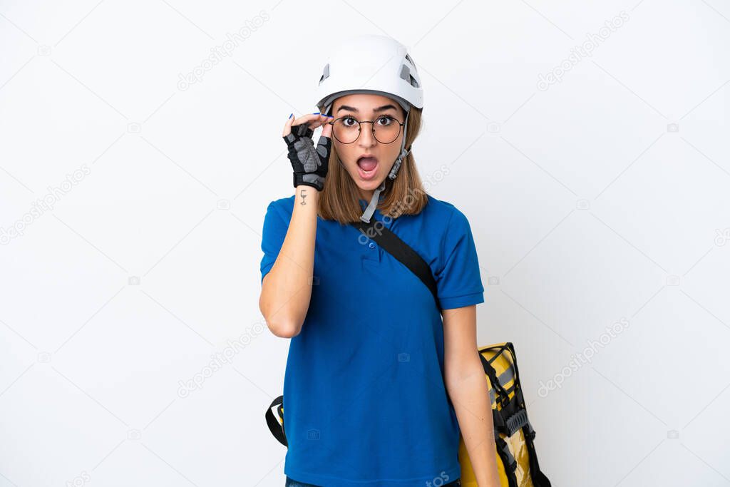 Young caucasian woman with thermal backpack isolated on white background with glasses and surprised