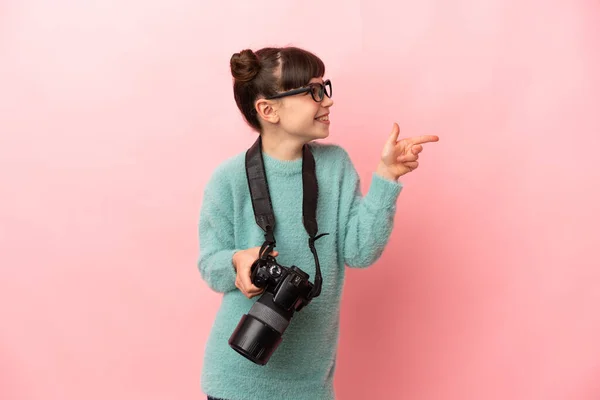 Little Photographer Girl Isolated Pink Background Pointing Finger Side — ストック写真