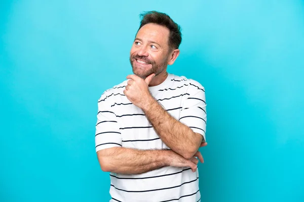 Middle Age Caucasian Man Isolated Blue Background Looking While Smiling — стоковое фото