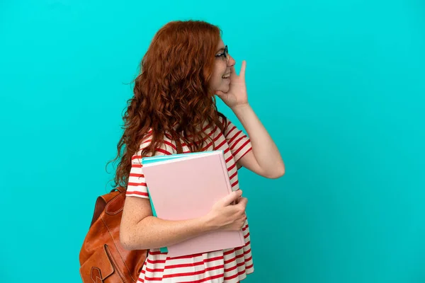 Student Teenager Redhead Girl Isolated Blue Background Shouting Mouth Wide — Fotografia de Stock