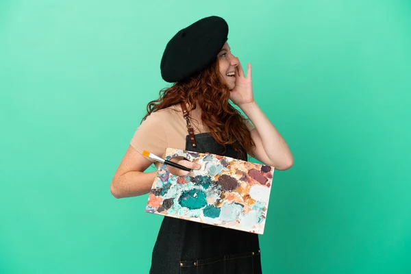 Teenager Redhead Artist Holding Palette Isolated Green Background Shouting Mouth — Foto de Stock