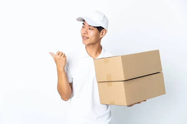 Delivery Chinese Man Isolated White Background Pointing Side Present Product — Stock Photo, Image