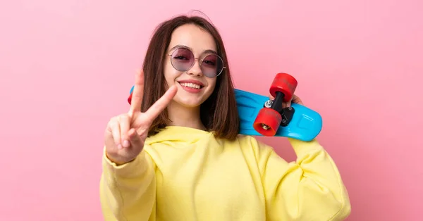 Young Ukrainian Woman Isolated Pink Background Skate Doing Victory Gesture — Zdjęcie stockowe