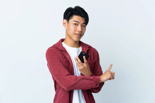 Young Chinese Man Isolated White Background Using Mobile Phone Pointing — 图库照片