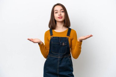 Young Ukrainian woman isolated on white background having doubts