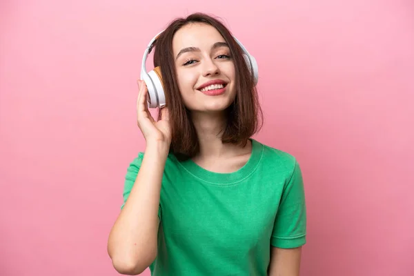 Young Ukrainian Woman Isolated Pink Background Listening Music — стоковое фото