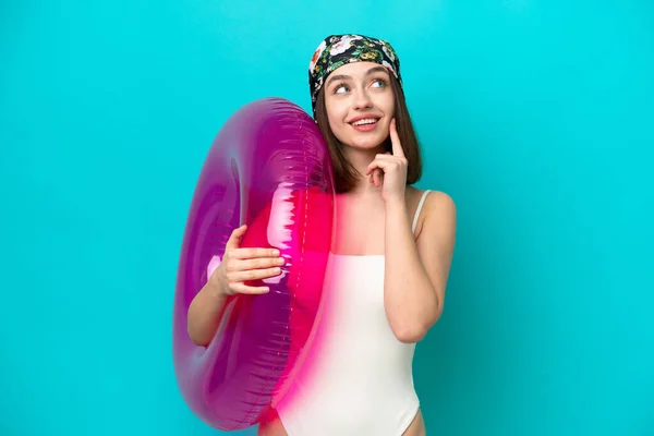 Young Ukrainian Woman Holding Air Mattress Isolated Blue Background Thinking — Stockfoto