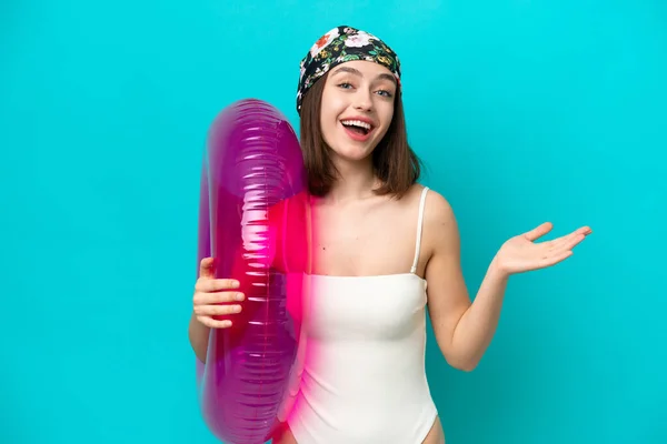 Young Ukrainian Woman Holding Air Mattress Isolated Blue Background Shocked — Stockfoto
