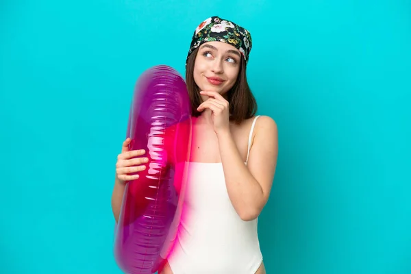 Young Ukrainian Woman Holding Air Mattress Isolated Blue Background Looking — ストック写真