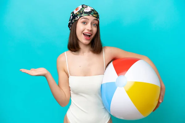 Young Ukrainian Woman Holding Beach Ball Isolated Blue Background Shocked — Stok fotoğraf