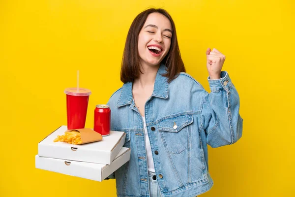 Young Ukrainian Woman Holding Fast Food Isolated Yellow Background Celebrating — Stock Photo, Image