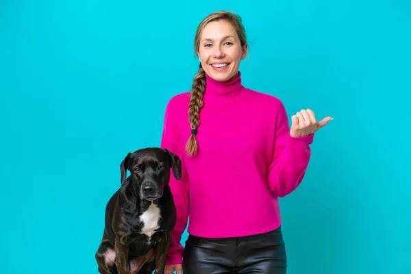 Young Caucasian Woman Her Dog Isolated Blue Background Pointing Side — Zdjęcie stockowe