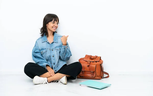 Young Student Woman Sitting One Floor Isolated White Background Pointing — Zdjęcie stockowe