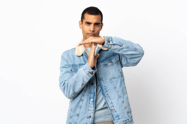 İzole edilmiş beyaz arka planı olan Afro-Amerikalı bir adam zaman aşımı hareketi yapıyor.