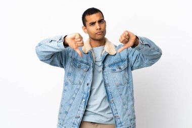 İzole edilmiş beyaz arka planda iki eliyle baş parmağını gösteren Afro-Amerikalı bir adam.