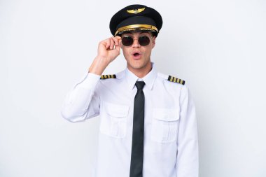 Airplane caucasian pilot isolated on white background with glasses and surprised