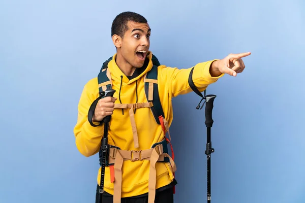 African American Man Backpack Trekking Poles Isolated Background Pointing Away — Foto Stock