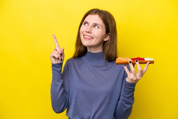 Young English Woman Holding Sashimi Isolated Yellow Background Pointing Great — стоковое фото