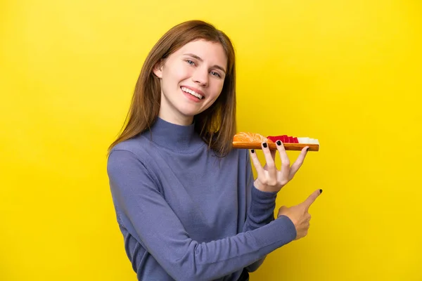 Young English Woman Holding Sashimi Isolated Yellow Background Pointing Back — Stock Fotó