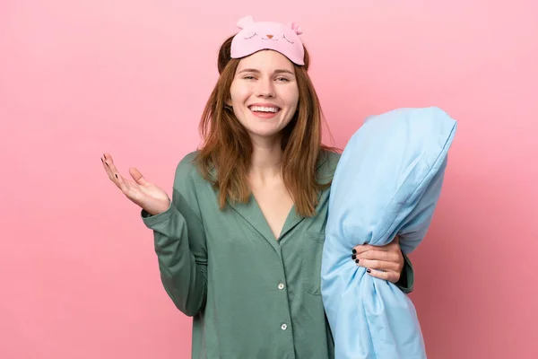 Young English woman in pajamas isolated on pink background in pajamas and with shocked facial expression