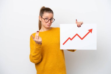 Young caucasian woman isolated on white background holding a sign with a growing statistics arrow symbol and doing coming gesture