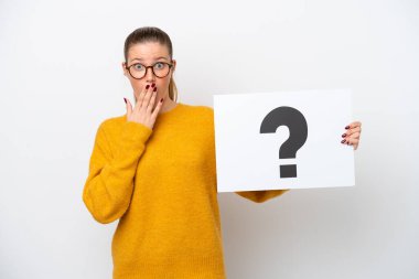 Young caucasian woman isolated on white background holding a placard with question mark symbol with surprised expression