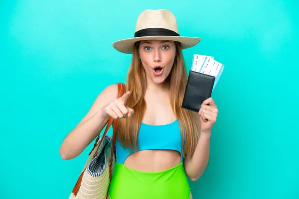 Traveler Caucasian Woman Holding Passport Isolated Blue Background Surprised Pointing — Stock fotografie