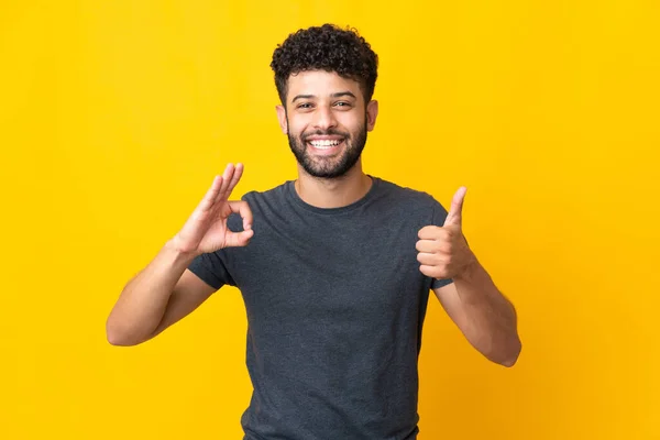 Young Moroccan Man Isolated Yellow Background Showing Sign Thumb Gesture — Stockfoto