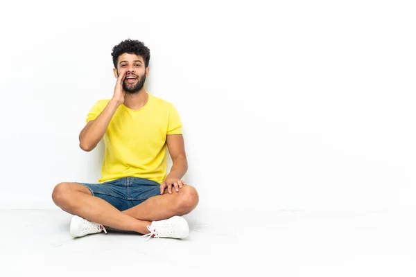 Young Moroccan Handsome Man Sitting Floor Isolated Background Shouting Mouth — Stockfoto