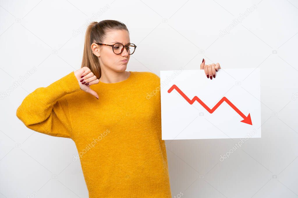 Young caucasian woman isolated on white background holding a sign with a decreasing statistics arrow symbol and doing bad signal