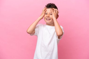 Little caucasian boy isolated on pink background laughing