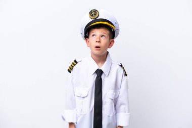 Little airplane pilot boy isolated on white background looking up and with surprised expression