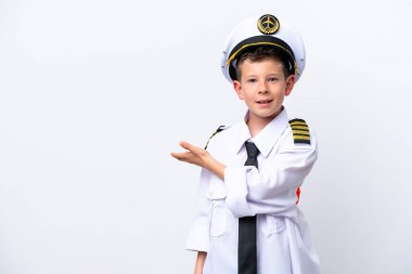 Little airplane pilot boy isolated on white background extending hands to the side for inviting to come