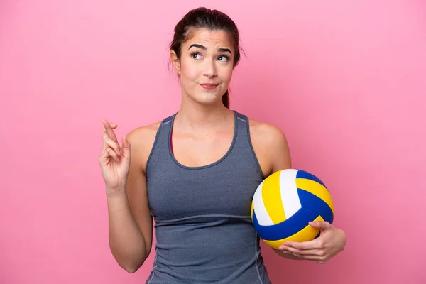 Young Brazilian Woman Playing Volleyball Isolated Pink Background Fingers Crossing — Zdjęcie stockowe